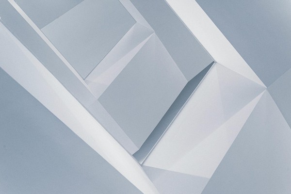Abstract geometric design featuring minimalist shades of blue and grey with sharp angles.